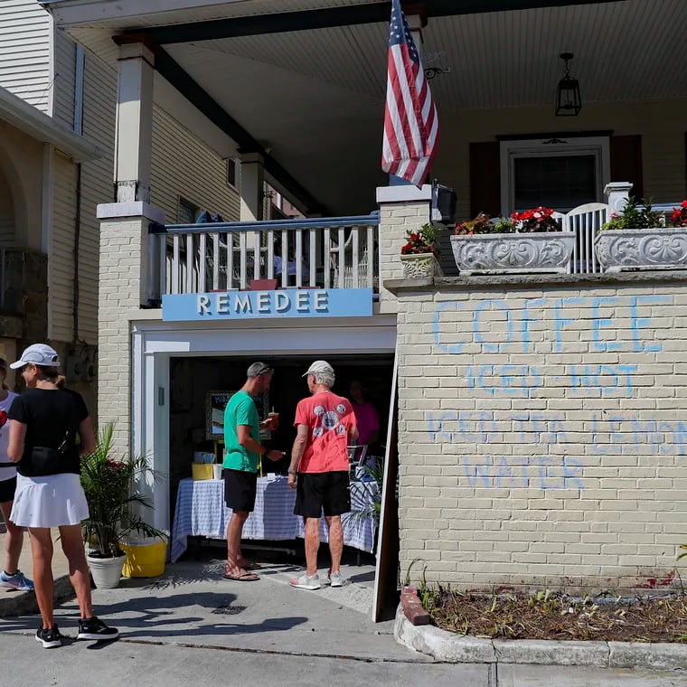 Customers wait in line at Remedee, where sisters Amanda and Colie Escobar run a small-batch craft coffee roastery  out of the garage of their Bartram Ave. beach home in Atlantic City, NJ on Saturday, July 23, 2022. The sisters are part of New Jersey's new Cottage food operator law that gives permits to home bakers to sell from their homes. They began the initiative during the pandemic.