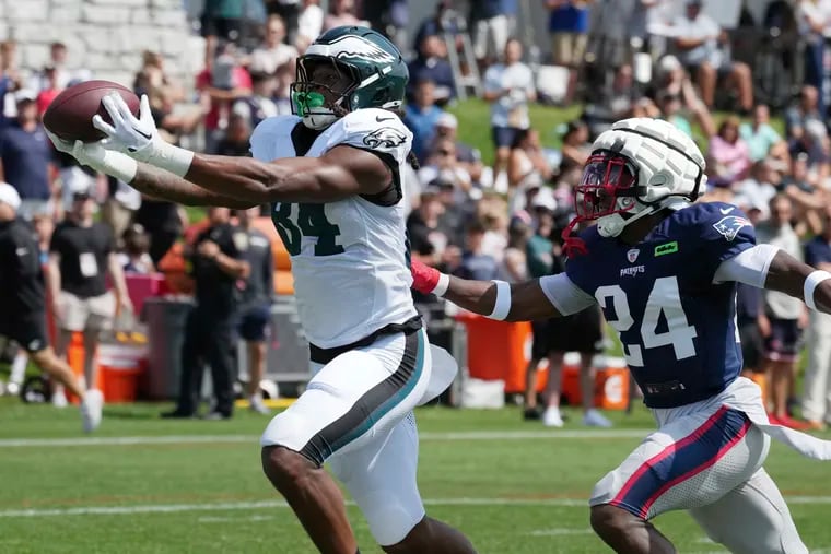 Eagles tight end E.J. Jenkins makes a catch as New England Patriots safety Joshuah Bledsoe defends during the joint practice in Foxborough, Mass.