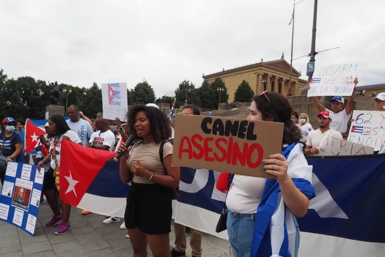 Cubans in Philadelphia, supporting the protests on the island against the Cuban regime, on the steps of the Art Museum July 18. Holding a sign is one of the organizers, Amalia Daché, an Afro-Cuban American scholar and an associate professor at the University of Pennsylvania. The sign next to Daché says "Canel Murderer," referring to Miguel Dí­az-Canel, president of Cuba. This was the biggest protest organized by this community in recent Philadelphia history with around 200 protesters.