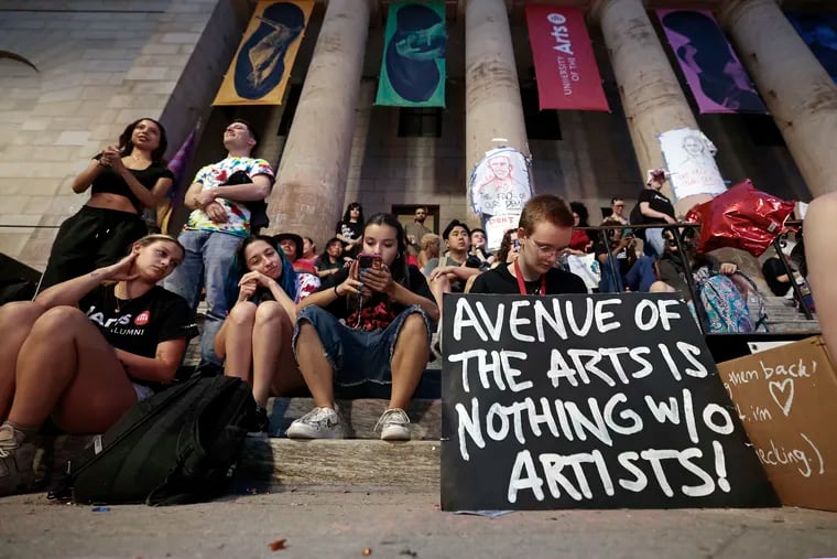 Rising sophomore Kaitlyn Duska (right) sits with her sign and other students during the “Last Stand Jam” in front of the University of the Arts Dorrance Hamilton Hall on South Broad Street on June 7.