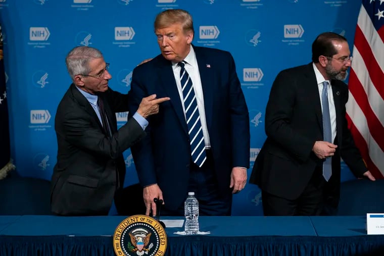 Dr. Anthony Fauci, director of the National Institute of Allergy and Infectious Diseases, left, President Donald Trump, center, and Secretary of Health and Human Services Alex Azar leave a briefing on the coronavirus at the National Institutes of Health, Tuesday, March 3, 2020, in Bethesda, Md. (AP Photo/Evan Vucci)