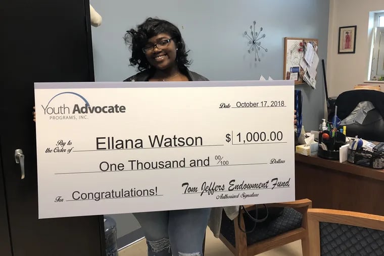 Ellana Watson, 22, holds a $1,000 check from Youth Advocates Program, or YAP, which awarded her a<br/>
college scholarship on Wednesday, Oct. 17, 2018. Watson, of North Philadelphia, was referred to Philadelphia YAP, or PYAP, by a judge in 2012. as an alternative to detention following her expulsion from school for fighting.