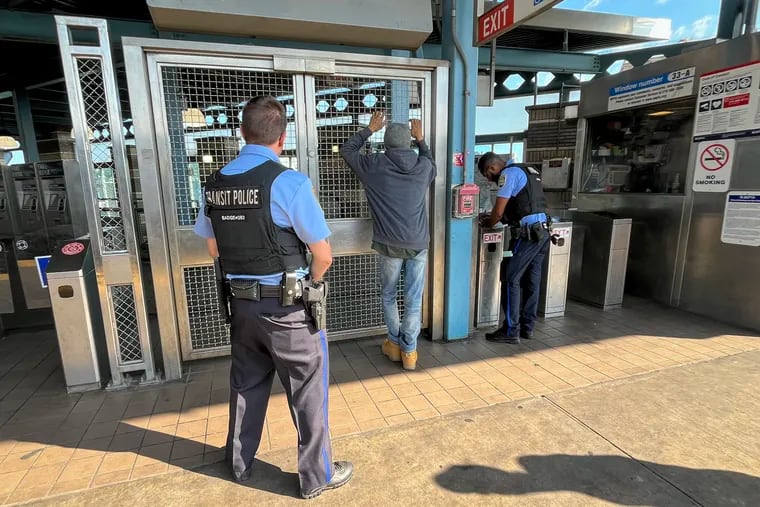 SEPTA Transit officers detain a man near turnstiles at Kensington and Allegheny Station on Friday, July 19, 2024.