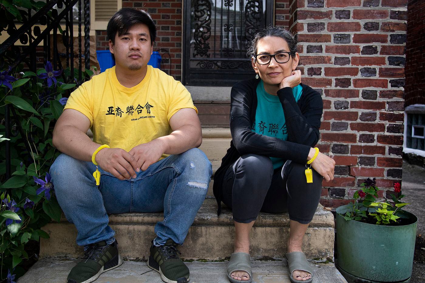 Alix Webb (right), executive director of Asian Americans United, and civic-engagement coordinator Wei Chen, are photographed with Yellow Whistles in West Philadelphia. The creators invite everyone to get and wear a whistle as a symbol of solidarity at a time of anti-Asian violence.