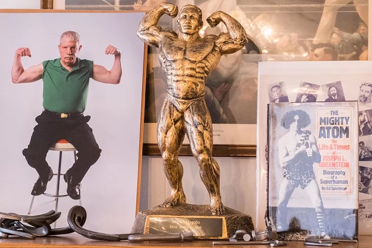 Manayunk's  strongman Mike Margolis, 74, can still bend 60D galvanized spikes with his bare hands. Here, old photos and memoribilia in Mike’s office.