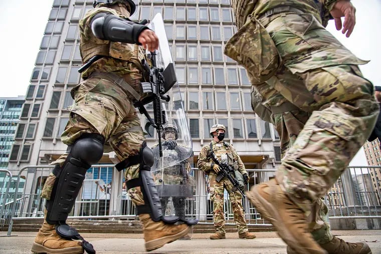 Members of the National Guard stand in front of the Philadelphia Municipal Services Building in Philadelphia on Oct. 31.