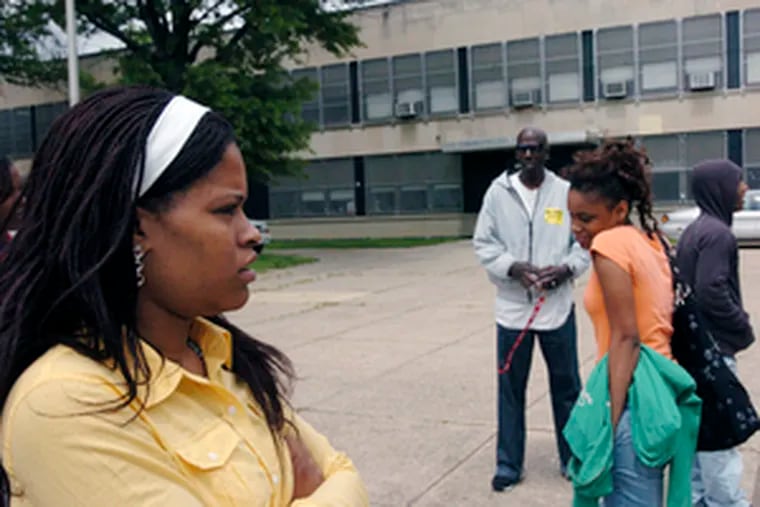 Concerned parent Lisa Scott (left) with daughter Ankia Towns (right) outside Lincoln High School yesterday.