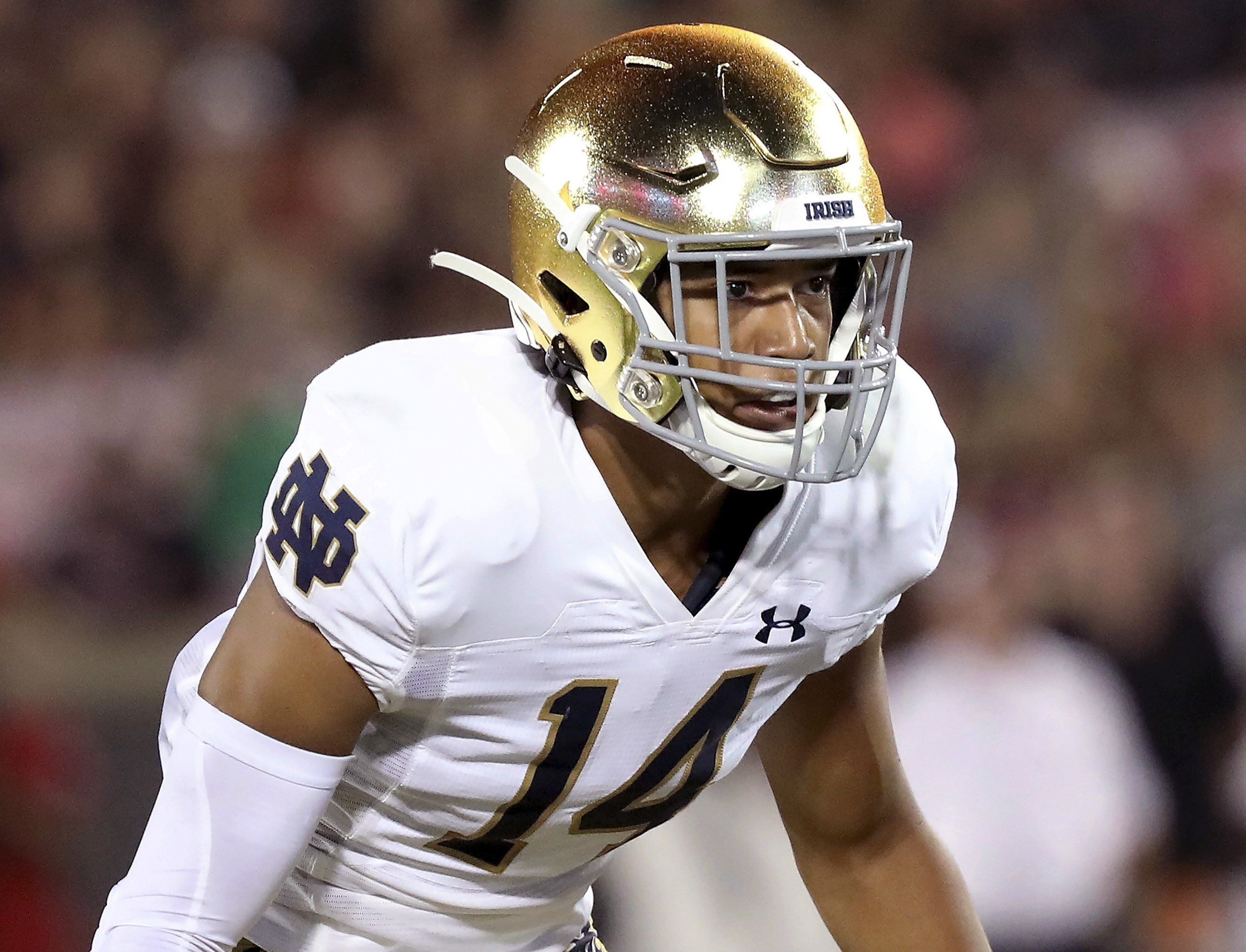 Notre Dame safety Kyle Hamilton holds a jersey after being chosen