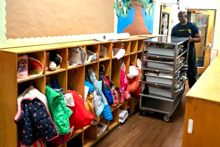 Cook’s aide James Percell takes food carts from the kitchen to classrooms at lunchtime at Children's Village in this photograph from Oct. 24, 2023.