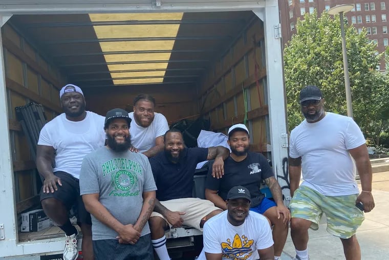 Tone Barr (front left, in the gray T-shirt) and a few of his 30 sponsors and volunteers at the second annual Feed the Homeless event in LOVE Park on Sunday. The event was sponsored by Philadelphia United as One and served an estimated 500 people.