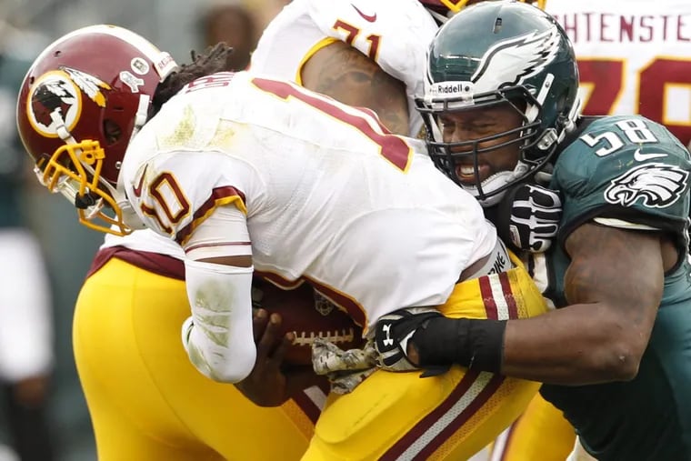 The Eagles’ Trent Cole sacks Redskins quarterback Robert Griffin III in a game back on Nov. 17, 2013 at Lincoln Financial Field.