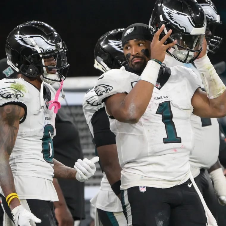 Eagles quarterback Jalen Hurts and Eagles wide receiver DeVonta Smith talk on the sideline during the third quarter in the season opener against the Green Bay Packers at Corinthians Arena in São Paulo, Brazil, Friday, Sept. 6, 2024.