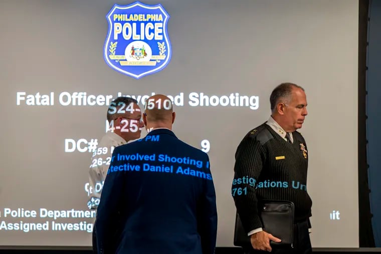 Deputy Police Commissioner Frank Vanore (right) arrives at the news conference Tuesday before showing video of the fatal shooting that left a suspect dead and an officer wounded.