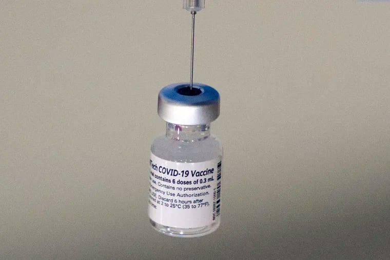 A syringe is placed into a vial of Pfizer-BioNTech vaccination at a COVID-19 clinic in Augusta, Maine, on Tuesday, Dec. 21, 2021. On Thursday, Oct. 20, 2022, Pfizer said it will charge $110 to $130 for a dose of its COVID-19 vaccine once the U.S. government stops buying the shots, but the drugmaker says it expects many people will continue receiving doses for free.