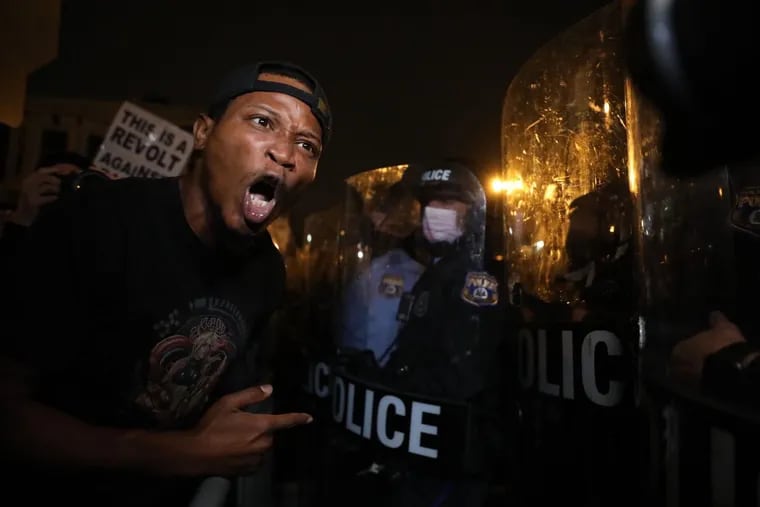 David Parker, an acquaintance to Walter Wallace Jr., yells at the line of police officers during a protest at 55th and Pine Street on Tuesday, Oct. 27, 2020. â€œI feel distraught,â€ Parker said. â€œI want to see a noticeable and prevalent difference in how police handle matters, period. The gun is not meant to solve anything. Physical restraint was all that is needed necessary.â€