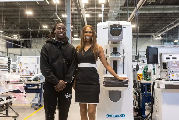 Tralee Hale, a breast cancer survivor, and her son Kelee Ringo, at one of the mammogram exam machines at Hologic in Newark, Del.