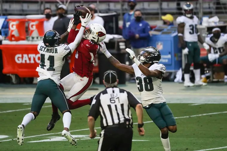 Arizona Cardinals WR DeAndre Hopkins makes the catch over the Eagles’ Kevon Seymour and Michael Jacquet in the second quarter of Sunday's 33-26 loss.