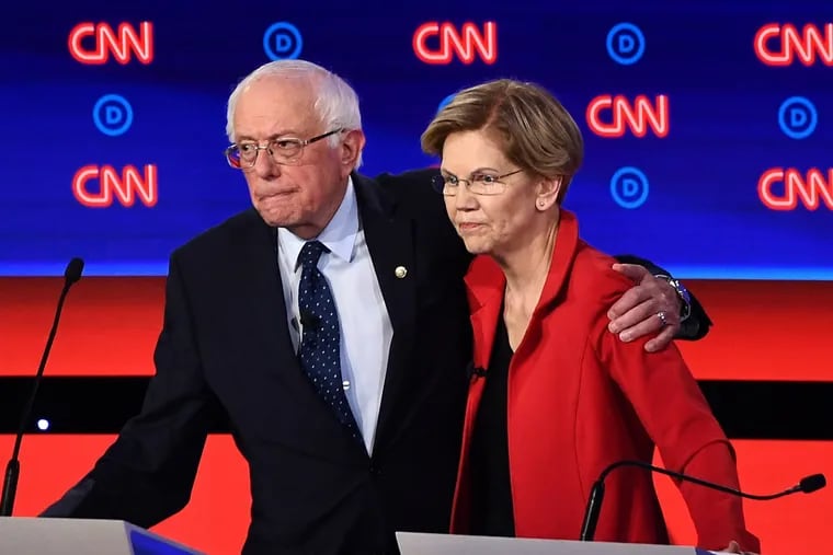 In this file photo taken on July 30, 2019, Democratic presidential hopefuls Sen. Bernie Sanders (I-Vt.), left, and Sen. Elizabeth Warren (D-Mass.) after participating in the first round of the second Democratic primary debate in Detroit. Sanders and Warren both support Medicare for All.