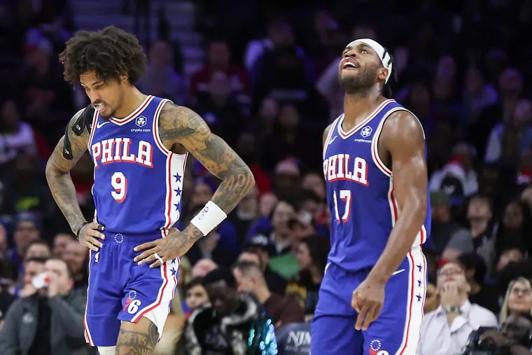 Sixers guards Kelly Oubre Jr. (left) and Buddy Hield walk to the bench during Wednesday night's loss to the Grizzlies.