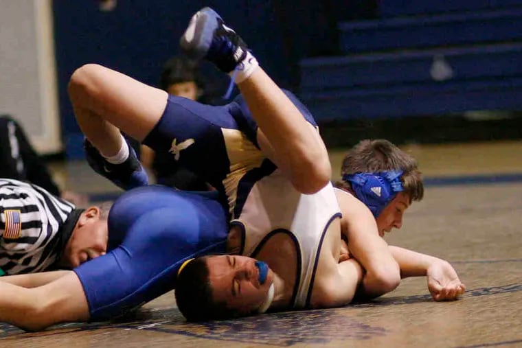 Bensalem's Tommy Stokes (in white) and Council Rock South's Nick Palmer grapple in the 103-pound bout. Stokes won, 7-0, and also won his other bout against Council Rock North in the double-dual meet. Bensalem lost both matches to Council Rock North and South.