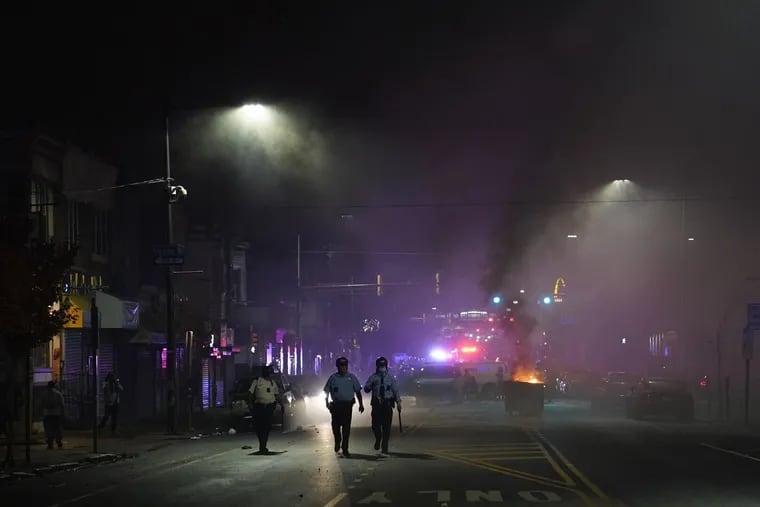 Officers walked along 52nd and Spruce Streets during a protest in response to the 2020 police shooting of Walter Wallace Jr. Police officers fatally shot the 27-year-old Black man during a confrontation in West Philadelphia that quickly raised tensions in the surrounding neighborhoods.