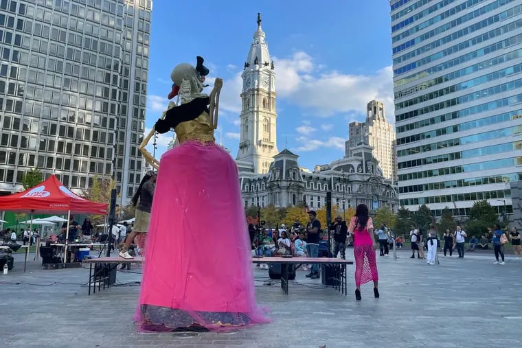 An altar by Mexican artist José Martín Anguiano Hermosillo towers over a fashion show in LOVE Park.