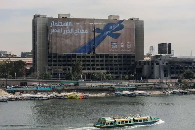 A transport boat on the Nile passes a banner that reads &quot;Investment is the key to Egypt's welfare&quot; as a major economic conference got underway.