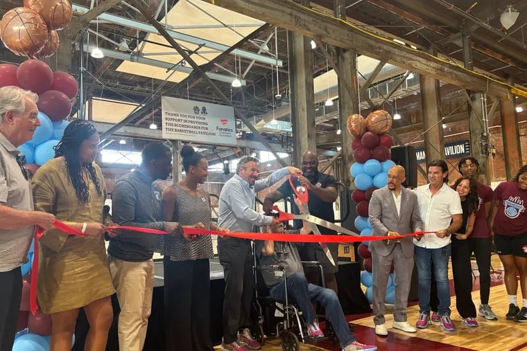 Alan Horwitz cuts the ribbon inside the newly built Alan Horwitz ‘Sixth Man’ Center on Tuesday. The building is part of Philadelphia Youth Basketball, an organization centered around the growth and development of underserved children.