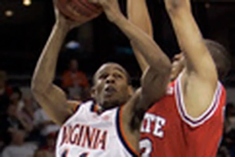 Virginia&#0039;s Sean Singletary goes up for a shot under coverage by N.C. State&#0039;s Brandon Costner in the ACC tournament. He led the Cavs to a share of the regular-season title.