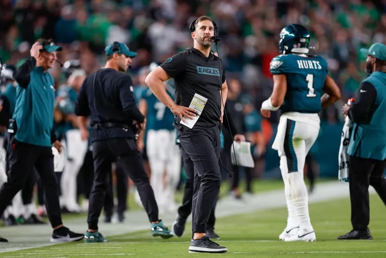 Eagles coach Nick Sirianni with Jalen Hurts during a timeout in the fourth quarter against the Falcons.