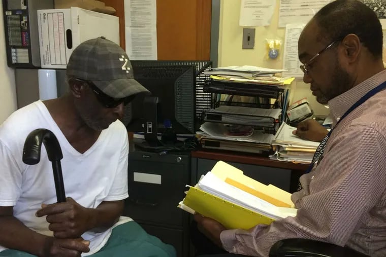 Julius Jackson (right), director of the Fernwood emergency-housing shelter, reviews Samuel Foster's file.