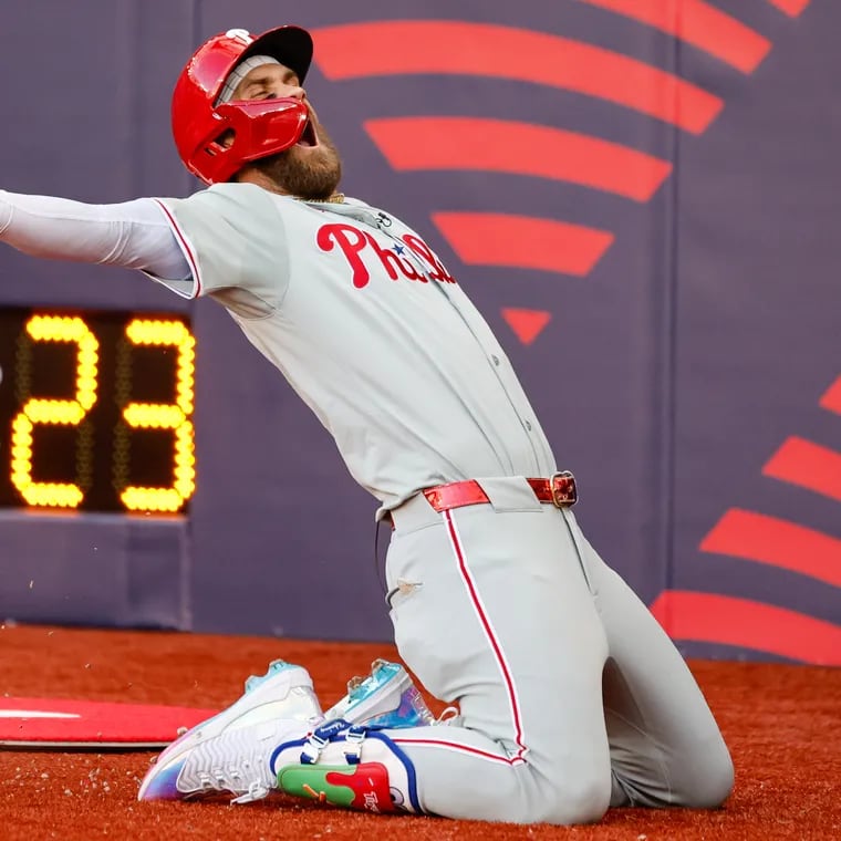 Phillies Bryce Harper celebrates a solo home run with a soccer style knee slide during the fourth inning against the Mets at London Stadium.