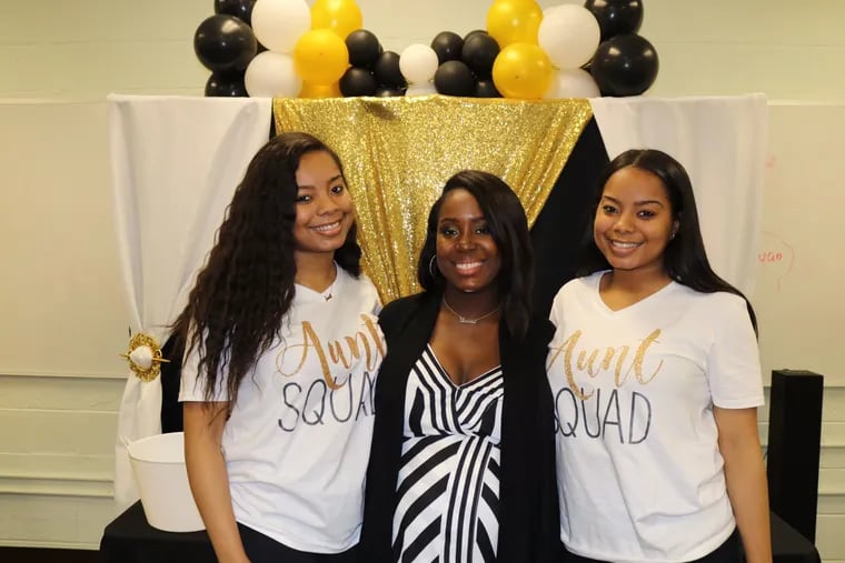 Tanisha Belton, senior manager of research initiatives at PolicyLab at Children's Hospital of Philadelphia, with her twin sisters, Ashli (left) and Asya (right). The twins were diagnosed with sickle cell disease as newborns.