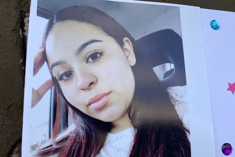 A photo of Crystal Roman-Benitez on display outside the house on the 2500 block of Ninth Street where police say she was killed by stray bullets.