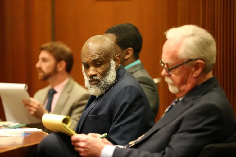 Supreme Life, center, looks in the direction of his lawyer, Michael Riley, right, as he faces murder charges in the stabbing death of Moriah Walker during the opening of the trial in the Burlington County Courthouse in Mt. Holly, NJ on March 13, 2019.