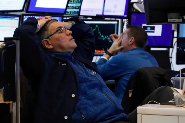 A pair of traders work in their booth on the floor of the New York Stock Exchange on Thursday.