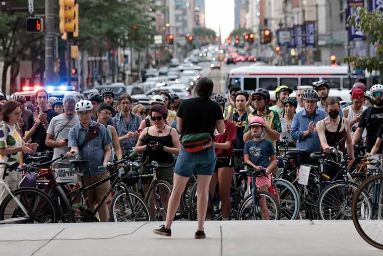 Philly Bike Action’s Yolanda Gomez-Galvez (back to camera) speaks to a group at City Hall in July protesting what they see as a lack of commitment to traffic safety from the mayor.