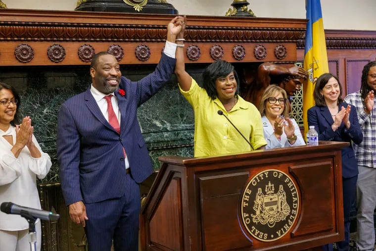 City Council President Kenyatta Johnson and Philadelphia Mayor Cherelle Parker raise hands together after they successfully passed the budget in June.