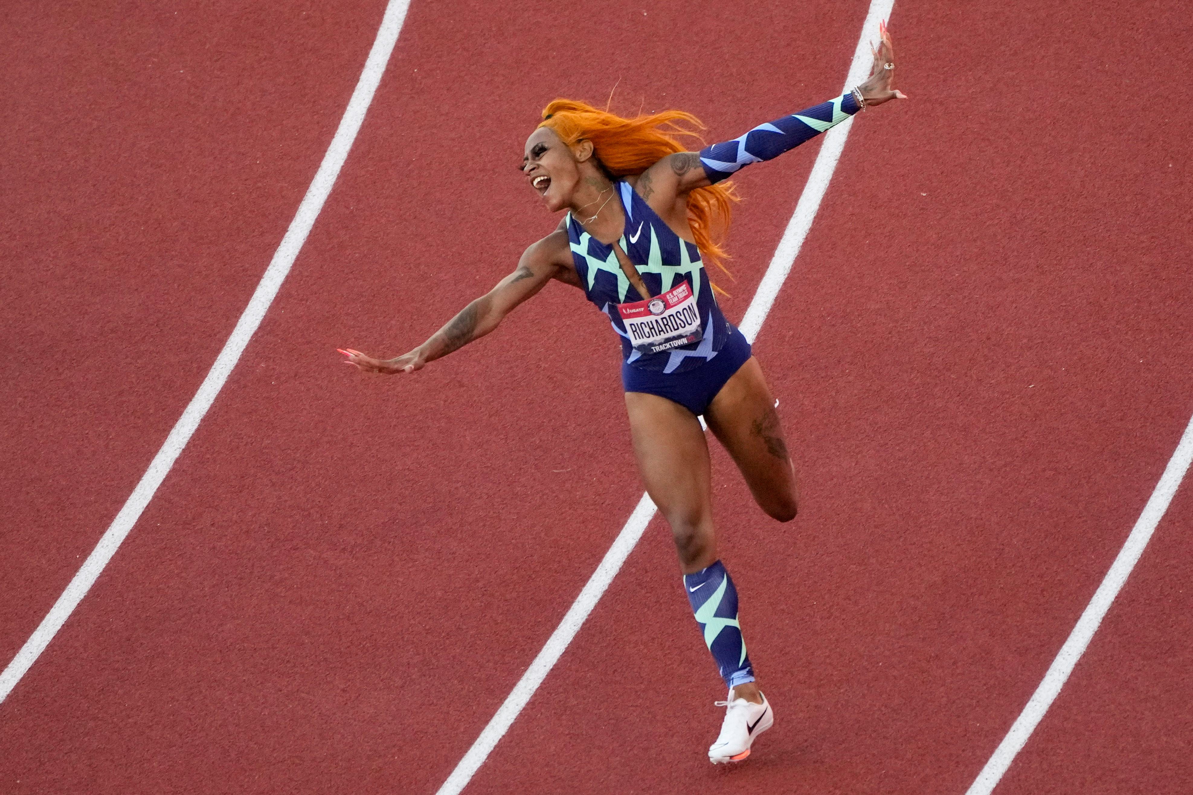 Cheer for Black girls with orange hair, long nails, tats, and lashes
