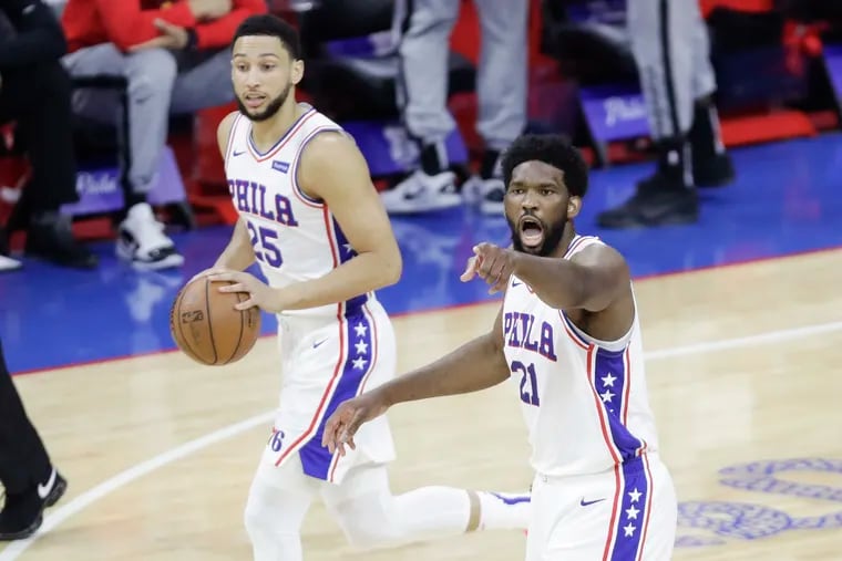Sixers center Joel Embiid (right) is perhaps pointing toward the basket to help teammate Ben Simmons find it. Simmons (left) did not shoot in the fourth quarters of the last four games against the Hawks.