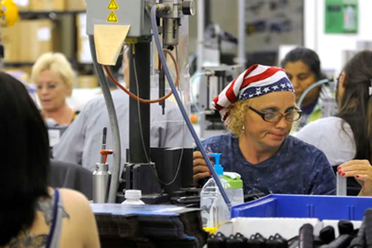 Betty Jo Durham working in red, white, and blue on the assembly line at Princeton Tectonic in Bordentown. She is not sure whom she will vote for next month. TOM GRALISH / Staff Photographer