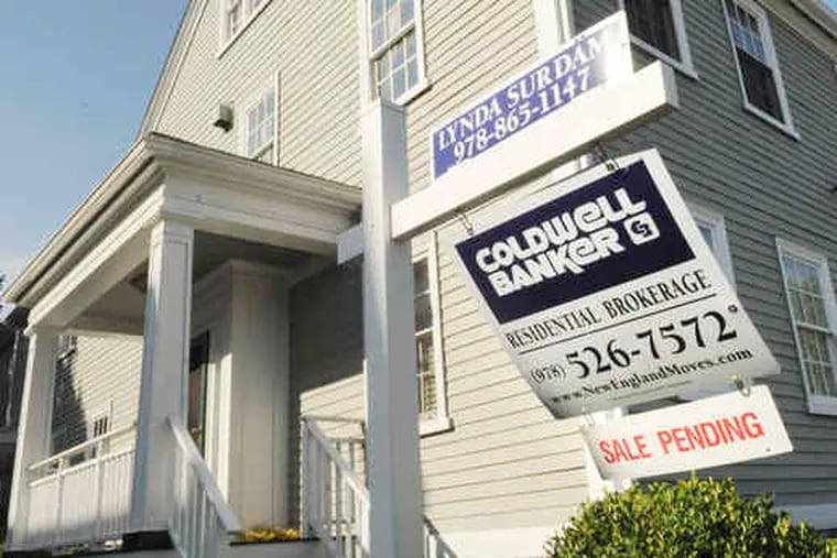 A sign shows a sale pending on a Massachusetts home. Resales in July posted the largest monthly gain in at least 10 years as first-time buyers took advantage of a federal tax credit.