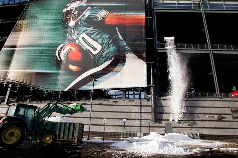 Crews remove snow from Lincoln Financial Field in advance of the Eagles-Vikings game that was postponed and moved to Tuesday night. More on C3.