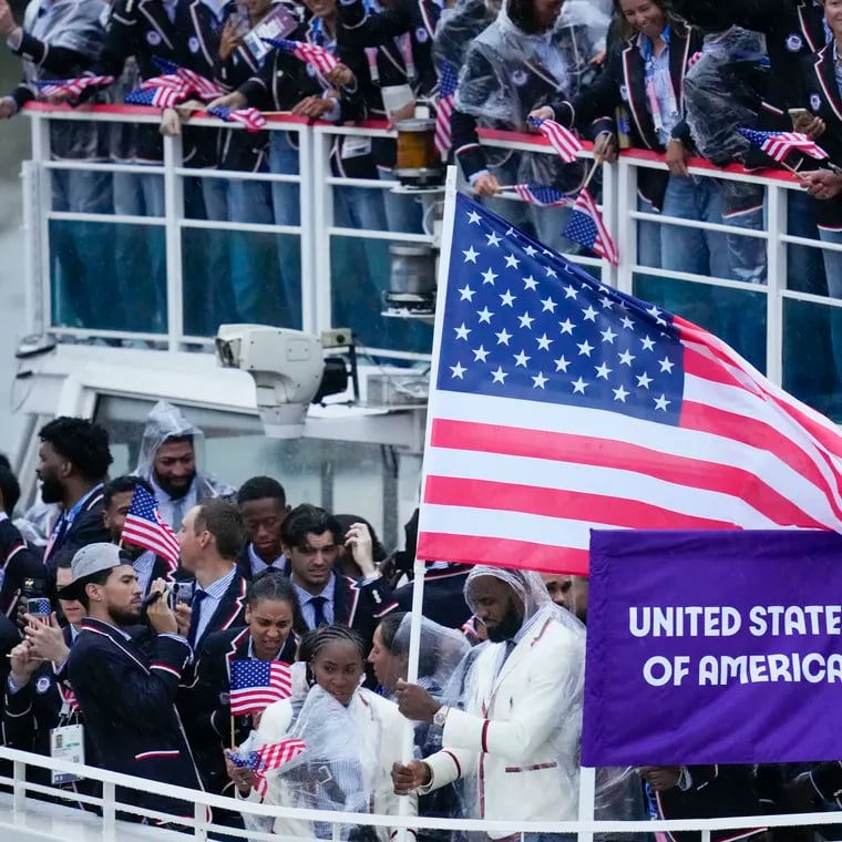 United States' Coco Gauff and Lebron James (bottom) travel with teammates along the Seine River in Paris, France, during the opening ceremony.