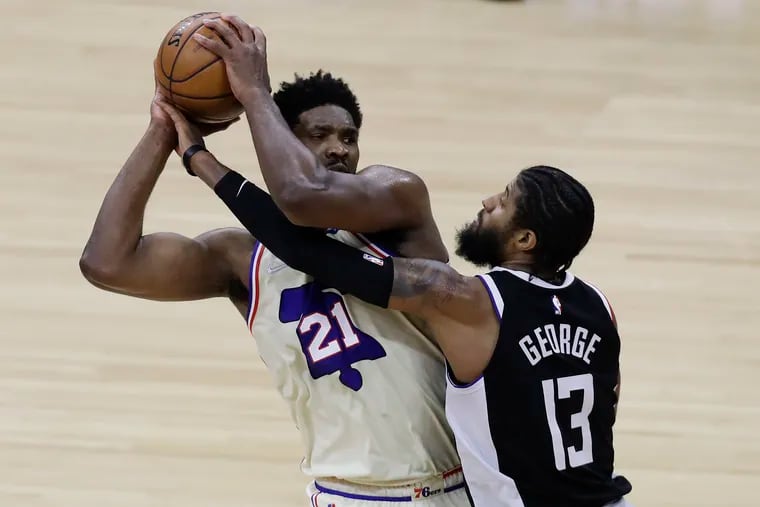 Joel Embiid gets fouled by Los Angeles Clippers guard Paul George during a game on April 16, 2021. George is a potential free-agent target for the Sixers this offseason.