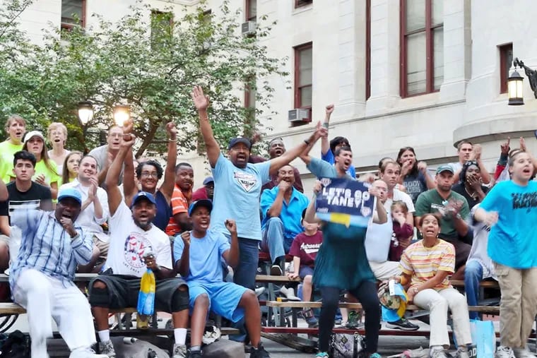 Mayor Nutter, standing center, cheers on the Taney Dragon with the rest of the crowd that gathered at City Hall for a Dragons Viewing party on Sunday, August 17, 2014.