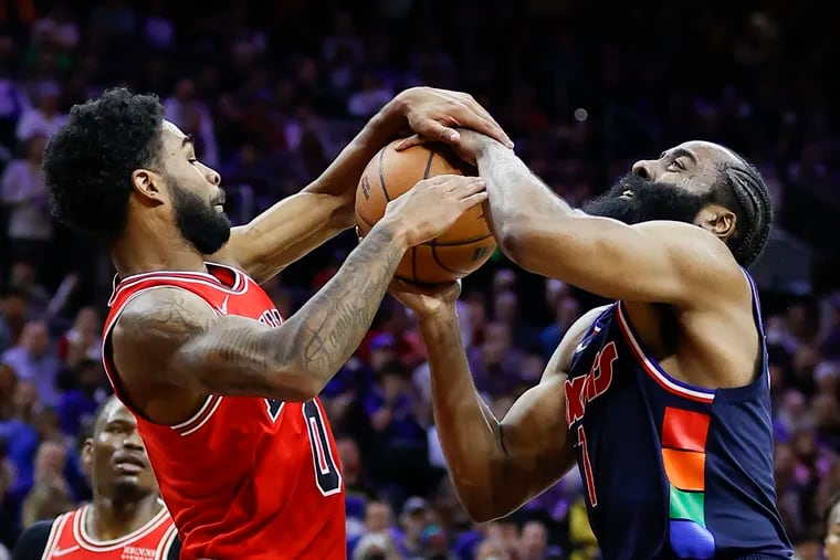 Sixers guard James Harden gets tied-up against Bulls guard Coby White.