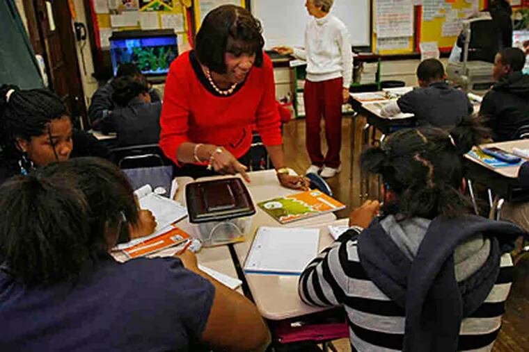 Reading teacher Eloise Overby (foreground) and math teacher Joanne Fidler work with students at Spring Garden School, which outperforms schools with similar student populations. (Alejandro A. Alvarez/Staff)