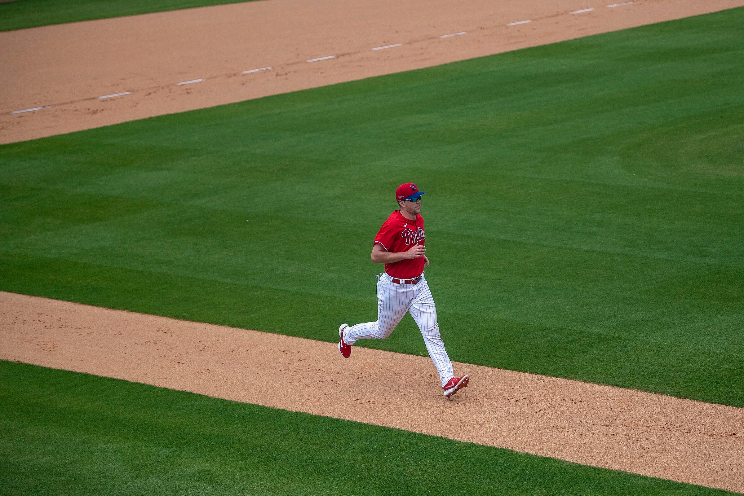 Philadelphia Phillies shortstop Scott Kingery (4) throws to first base  during a spring training baseball game against the Philadelphia Phillies on  March 26, 2023 at Ed Smith Stadium in Sarasota, Florida. (Mike