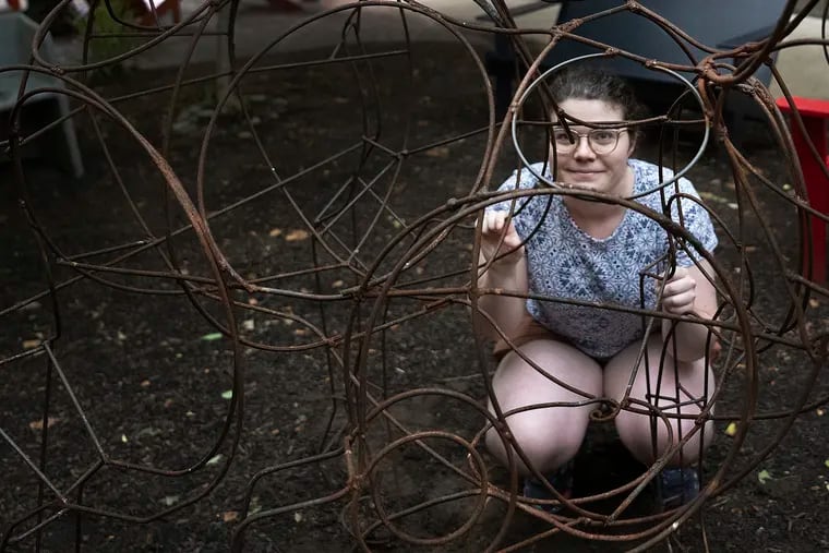 University of the Arts student Zivia Brown pose for a photo with her steel goat statue minutes before removing it from a university courtyard.